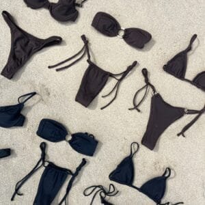Joy Sportwear Custom Classic Black Bikini Collection. Solid color bikinis in triangle, bandeau, and thong styles.