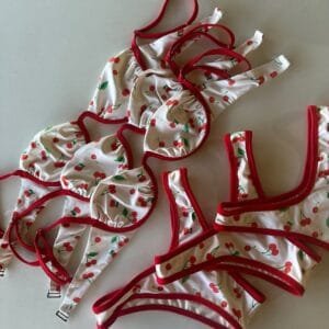 Joy Sportwear custom cherry print underwire bikini. White with all-over red cherry pattern and red trim.