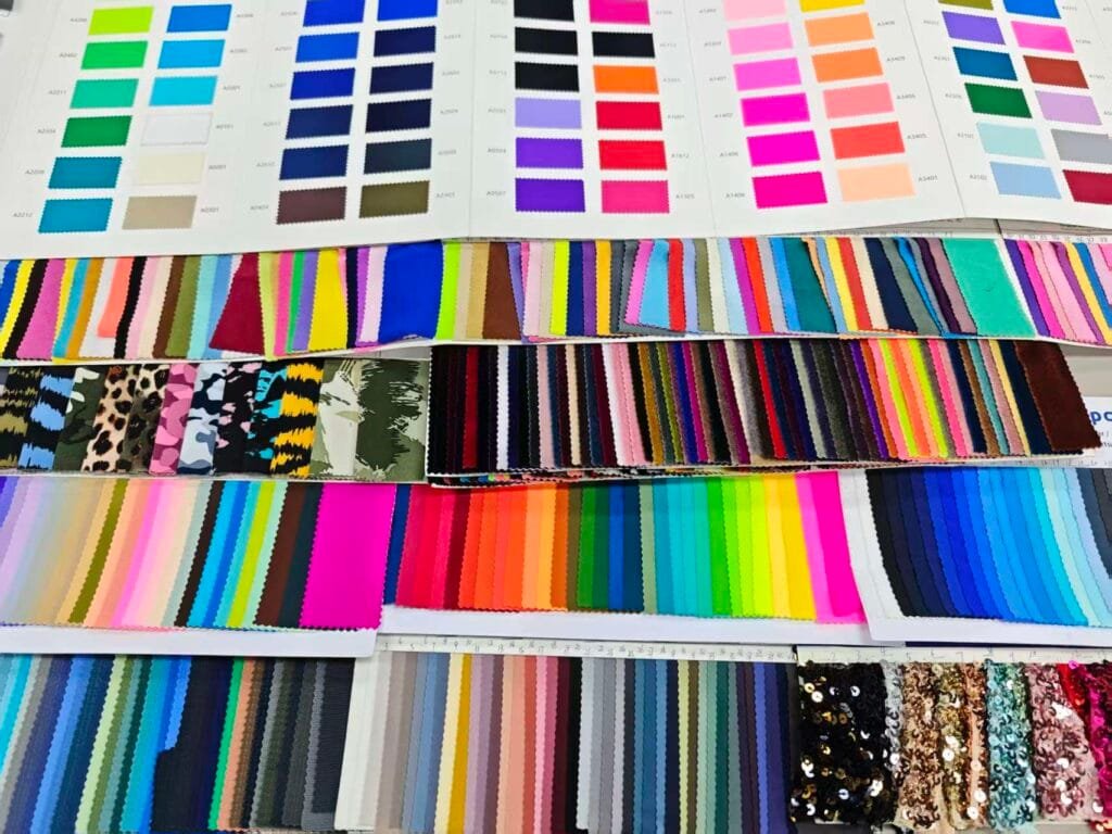 Assorted swimsuit fabric swatches used for color and material selection.