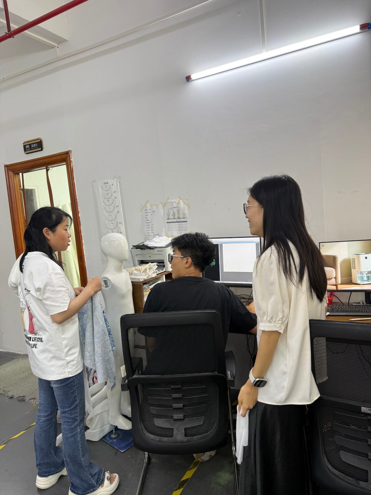 Joysportwear — Close-up of quality inspection of a swimwear fabric at the factory